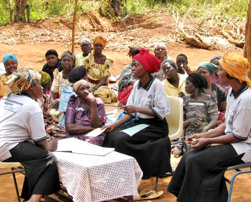 African woman teaching microfinance in village