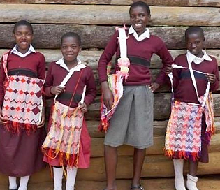 Rukundo girls modeling handmade shoulder bags.