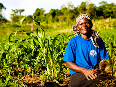 African Female With Crop Farm