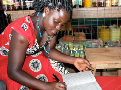 African Woman Keeping Business Logs