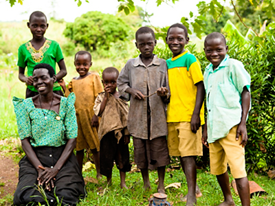 African Woman With Children Smiling Outside