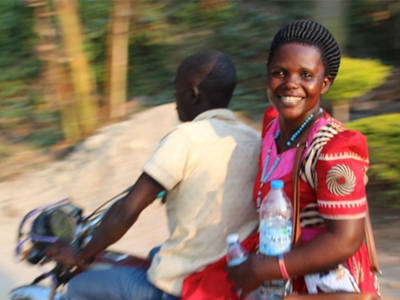 Smiling woman on moped